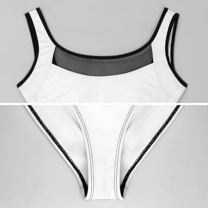White swimsuit with black trim on a gray background