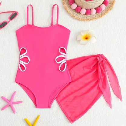 Pink swimsuit with floral designs on a white background