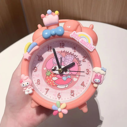 Pink cartoon clock held by a hand with a colorful design on a light background