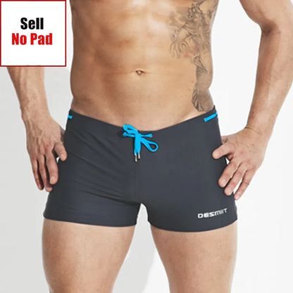 Man wearing black swim shorts with blue drawstring on a white background