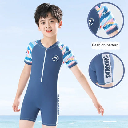 Child wearing a blue swimsuit with colorful patterns on a light blue background