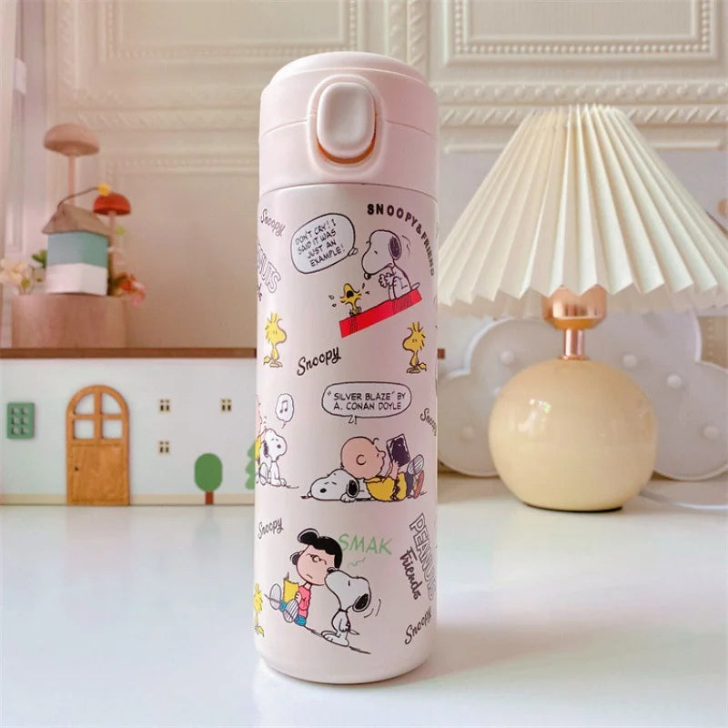 Pink water bottle with Snoopy and Woodstock illustrations on a white surface.