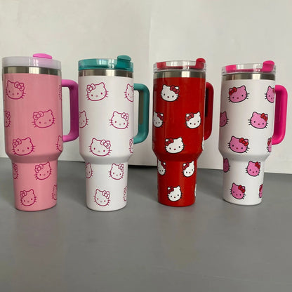 Four Hello Kitty-themed tumblers in different colors on a gray surface.