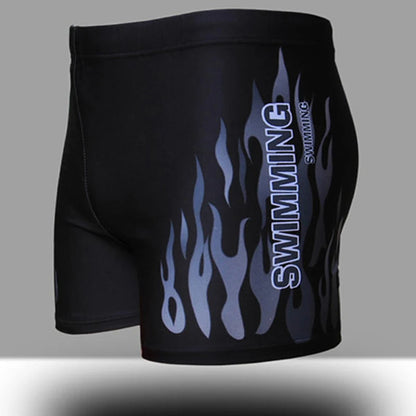 Black swim shorts with flame design and 'Swimming' text on a gray background