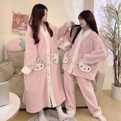 Two people wearing pink Hello Kitty-themed pajama sets in a cozy living room.