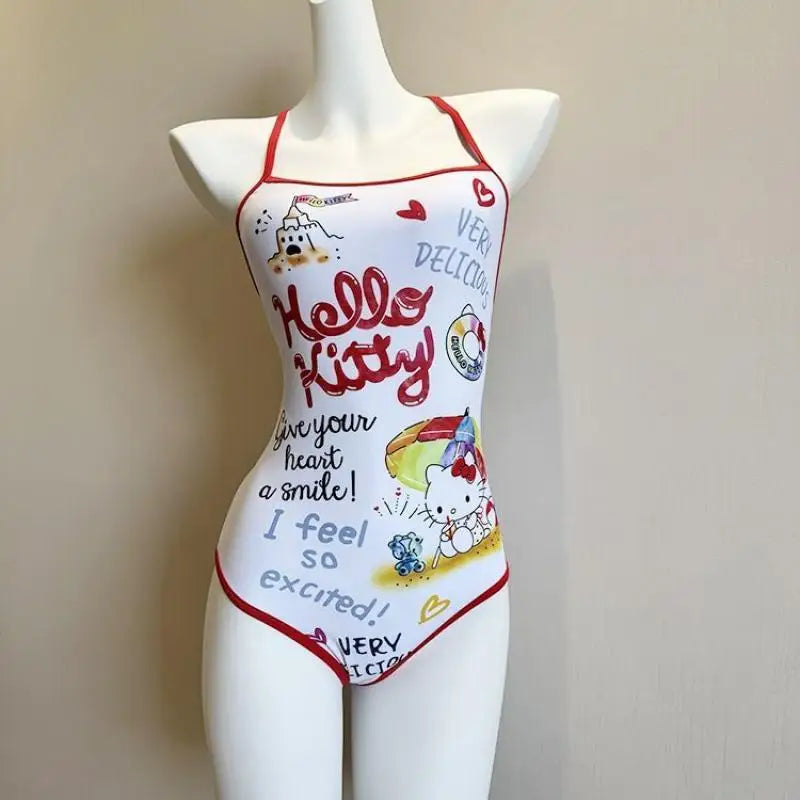 Mannequin wearing a Hello Kitty swimsuit with colorful graphics and text on a plain background