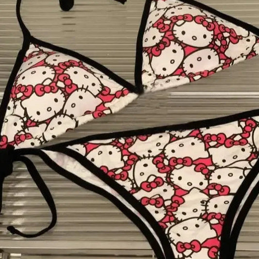 Hello Kitty patterned bikini set on a hanger against a neutral background