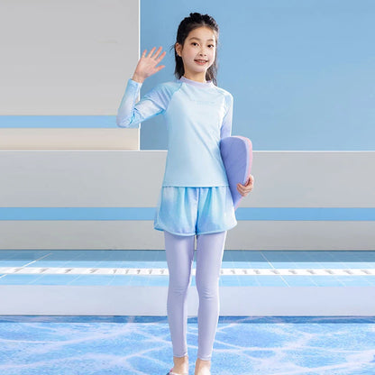 Young girl in light blue athletic wear holding a pink yoga mat on a striped background