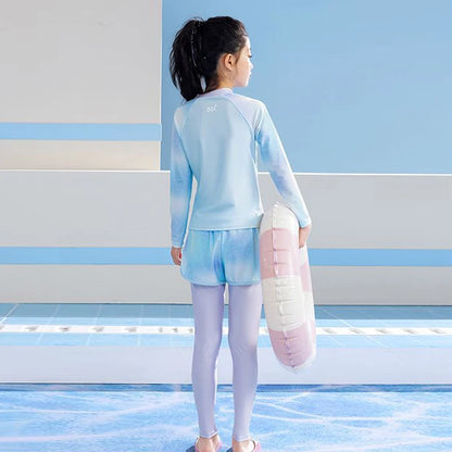 Child in light blue swimsuit holding a pink inflatable ring on a pool deck.