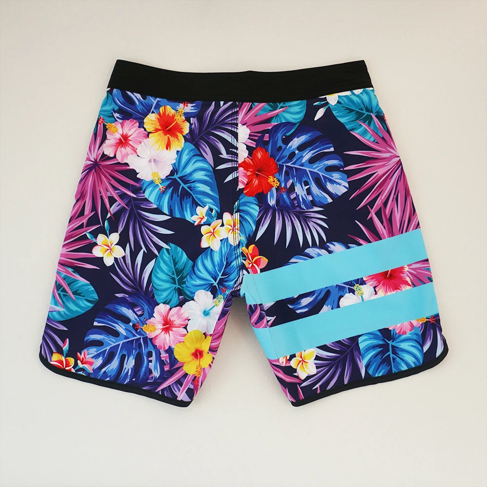 Colorful tropical floral shorts on a light gray background