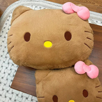 Plush toy resembling a cat with pink bows on a wooden surface