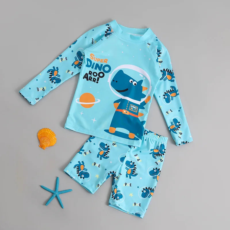 Children's blue dinosaur-themed swimsuit set with shell and starfish on a gray background