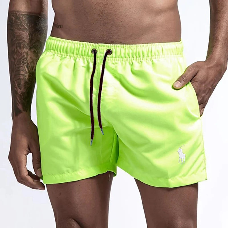 Neon green swim shorts with a brand logo on a white background