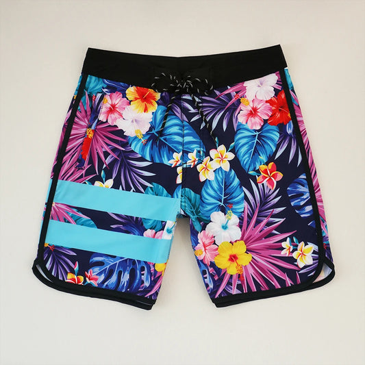 Colorful tropical floral shorts on a light gray background