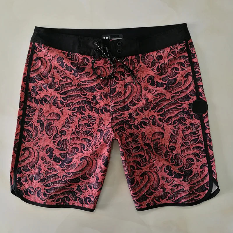 Pink and black patterned shorts on a light gray background