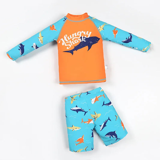 Children's shark-themed rash guard and swim shorts set on a white background