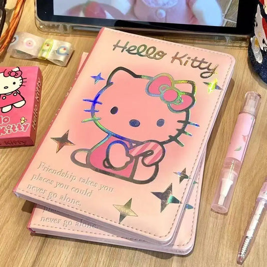 Hello Kitty notebook on a wooden surface with stationery items around
