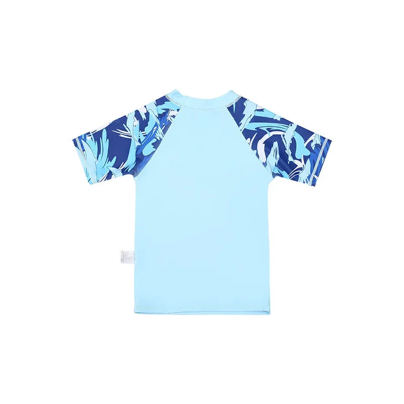 Light blue children's shirt with dark blue leaf pattern on sleeves against a white background