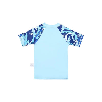 Light blue children's shirt with dark blue leaf pattern on sleeves against a white background