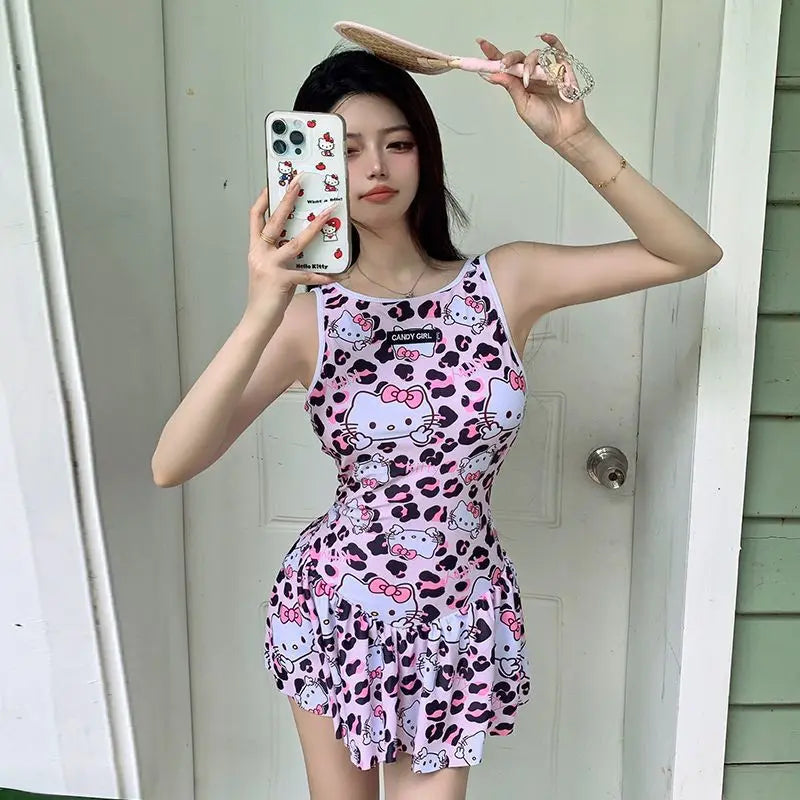 Person wearing a pink Hello Kitty dress taking a mirror selfie.