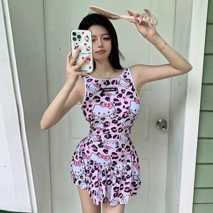 Person wearing a pink Hello Kitty dress taking a mirror selfie.