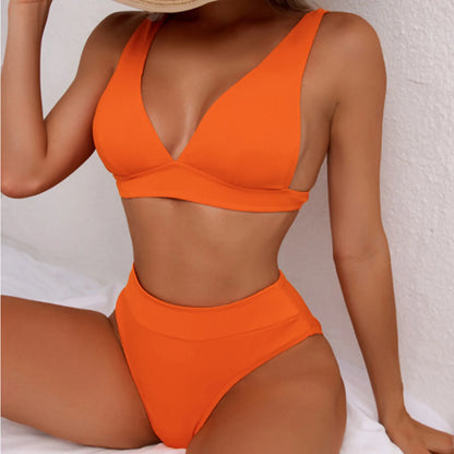 Person wearing an orange bikini set against a white background