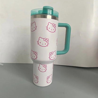 White tumbler with pink Hello Kitty faces and a teal handle and lid on a white background.