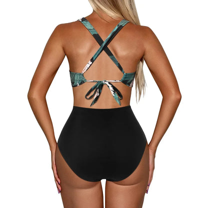 Black swimsuit with green leaf patterns on a white background