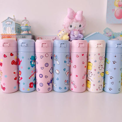Set of colorful water bottles with cartoon designs on a white surface.