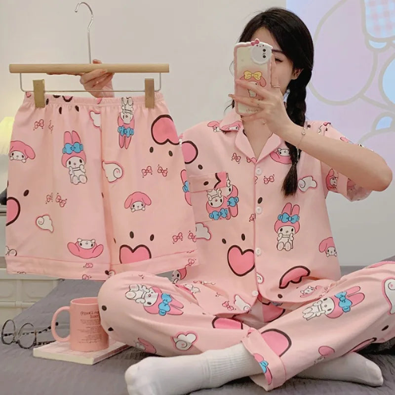 Person wearing a pink cartoon-themed pajama set with matching shorts, sitting on a bed.