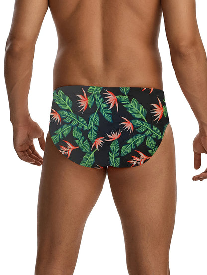Tropical leaf patterned swim briefs on a plain background