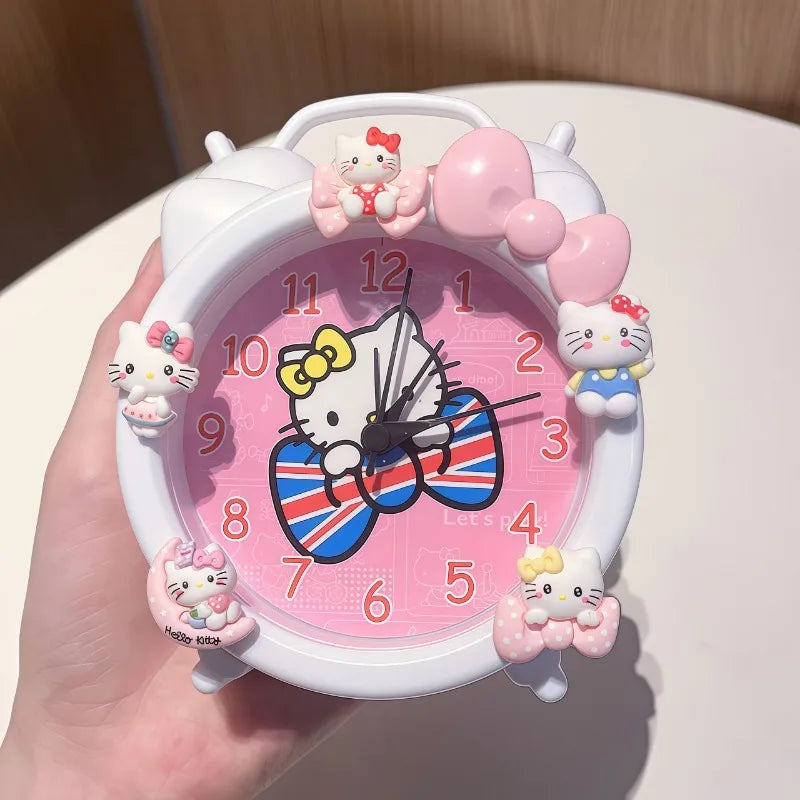Hello Kitty-themed clock with a Union Jack bow design, held by a hand.