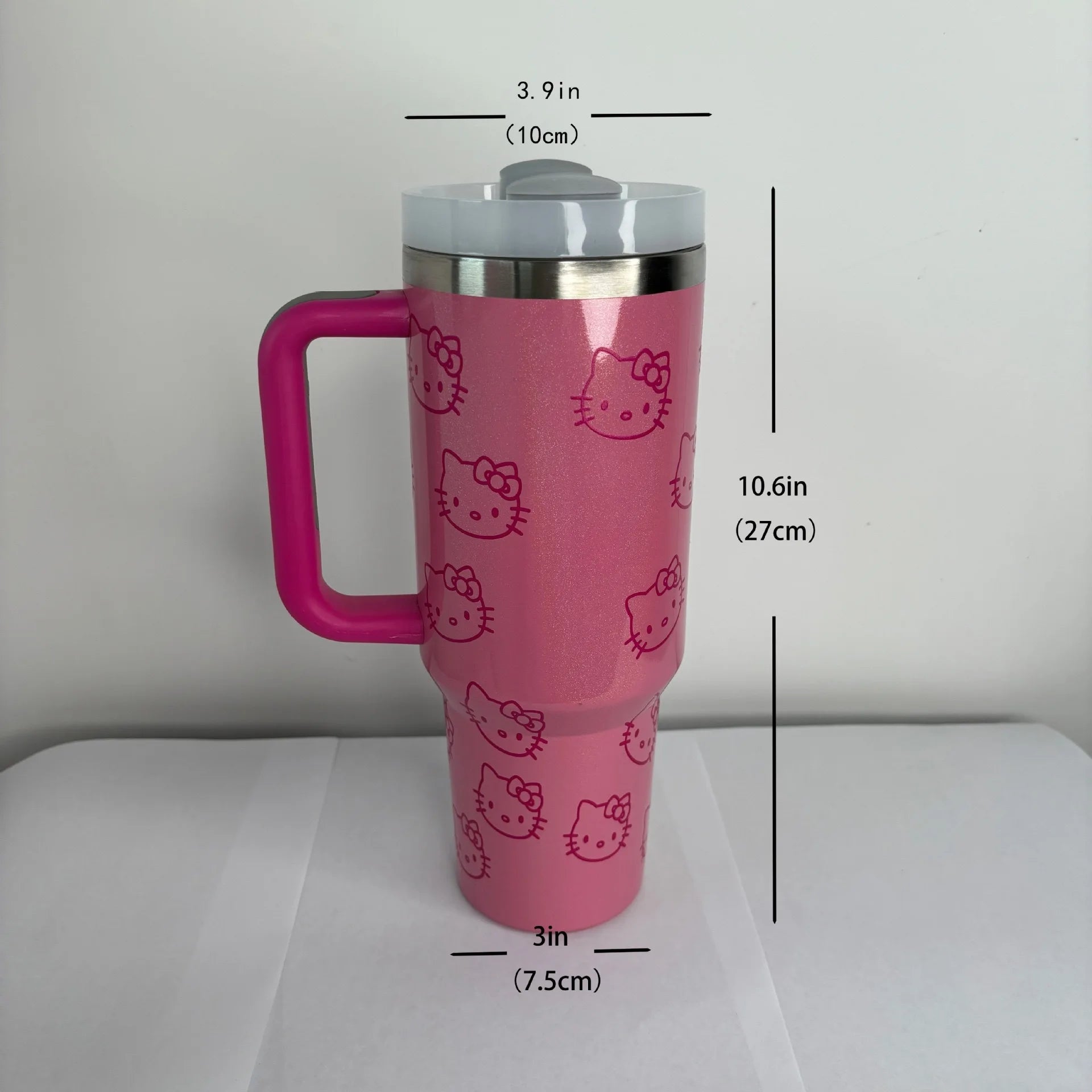 Pink tumbler with Hello Kitty designs and measurements on a white background