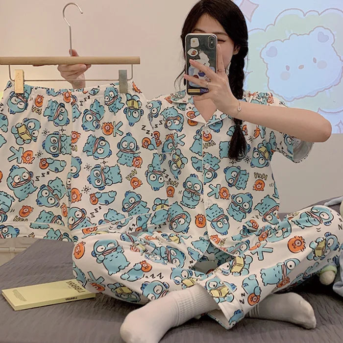 Person wearing a pajama set with cartoon character pattern in a room.