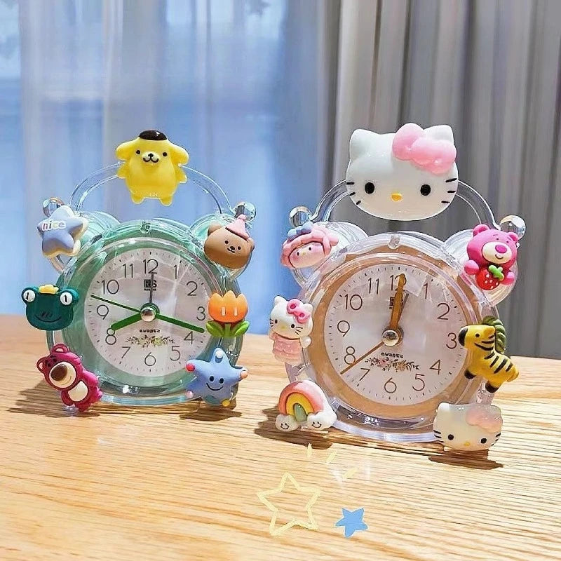 Two decorative clocks with cartoon character figurines on a wooden surface.