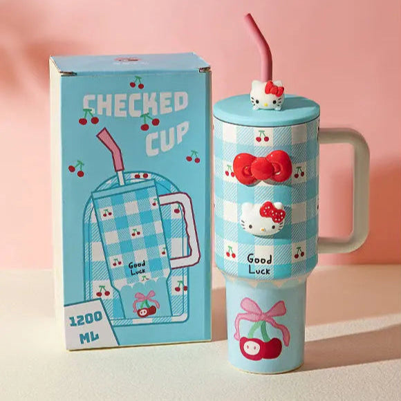 Blue tumbler with cartoon character and packaging on a pink background