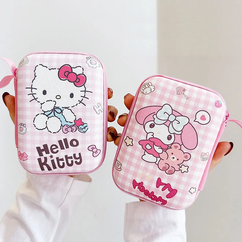Two pink Hello Kitty pouches held by a person against a white background