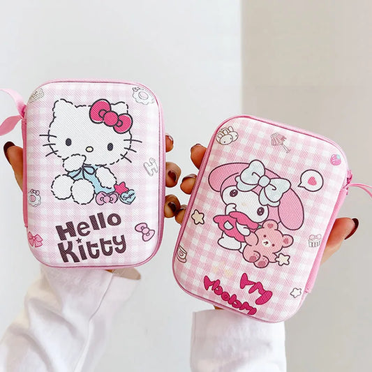 Two pink Hello Kitty pouches held by a person against a white background