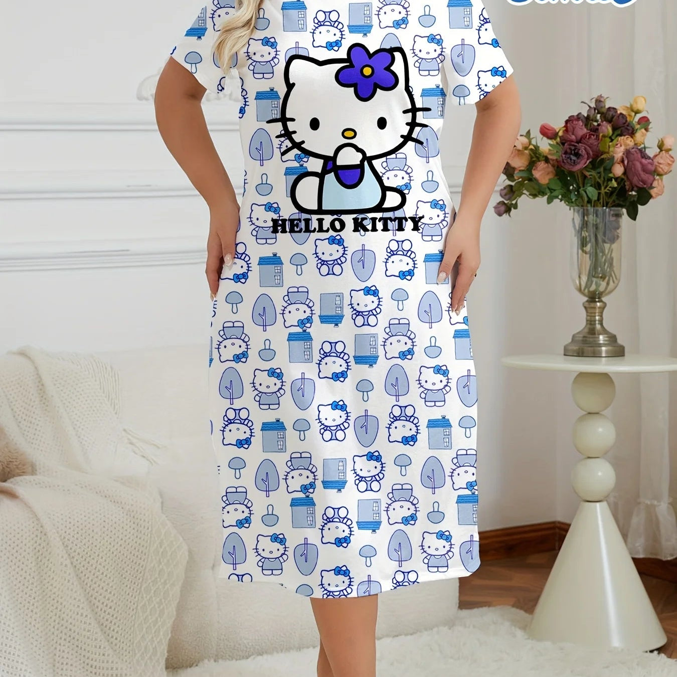Woman wearing a Hello Kitty dress with blue patterns in a room setting.