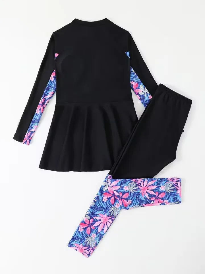Black top and leggings with colorful floral patterns on a white background