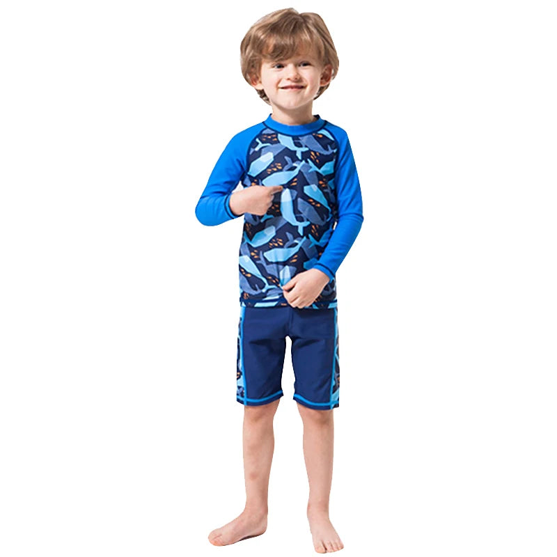 Child wearing a blue and gray shark-patterned swimsuit on a white background