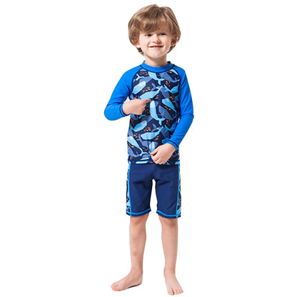 Child wearing a blue and gray shark-patterned swimsuit on a white background