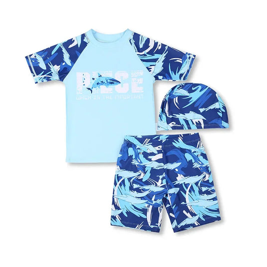 Children's shark-themed swim set with shirt, shorts, and hat on a white background