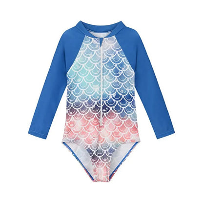 Children's swimsuit with blue sleeves and colorful scale pattern on a white background