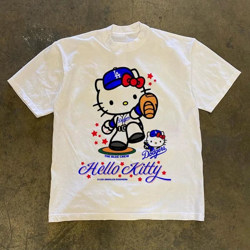 White t-shirt with Hello Kitty Los Angeles Dodgers graphic on a brown surface