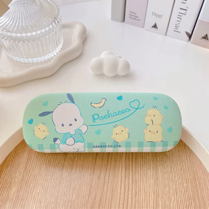 Cute cartoon-themed glasses case on a wooden surface with a light background