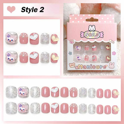 Set of pink and silver nail art designs with packaging labeled 'Manicure' on a pink background.