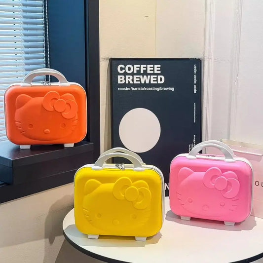 Three colorful Hello Kitty-style suitcases on a table with a 'Coffee Brewed' sign in the background.
