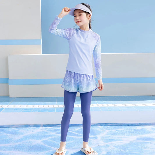Child wearing a light blue long-sleeve shirt and purple leggings with a matching visor against a blue and gray background.