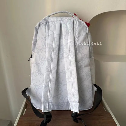Light gray backpack with floral pattern on a chair against a plain wall.